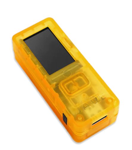 The Blockstream Jade, a compact, yellow, rectangular electronic device with a transparent casing, is featured. It includes a black screen and a USB port at one end. The clear plastic reveals visible buttons and internal components. This Bitcoin wallet is celebrated in Sydney for its sleek and minimalistic design.